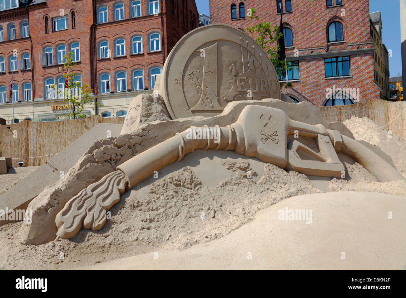Copenhagen, Denmark. May 30th 2013. 17 sand sculptures of up to 10 metres height built from 3,000 tons sand by 30 international sand artists are on display until August 25th at Havnegade in the port of Copenhagen in one of the most spectacular sand sculpture events in northern Europe. 'Bye Bye Mister Money' by Etual Ojeda, Spain. This sculpture expresses a straightforward critisism of the money mechanics. It represents a dying structure that is corrupted and not functional. Historic buildings at Havnegade in the background. Credit:  Niels Quist / Alamy Live News Stock Photo