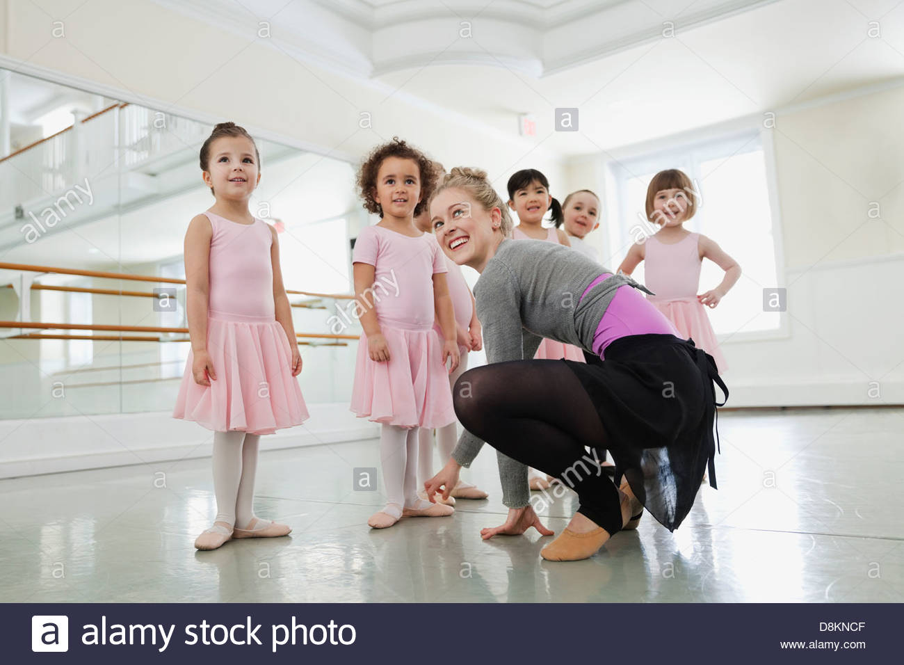 Female ballet instructor teaching children in ballet studio Stock Photo