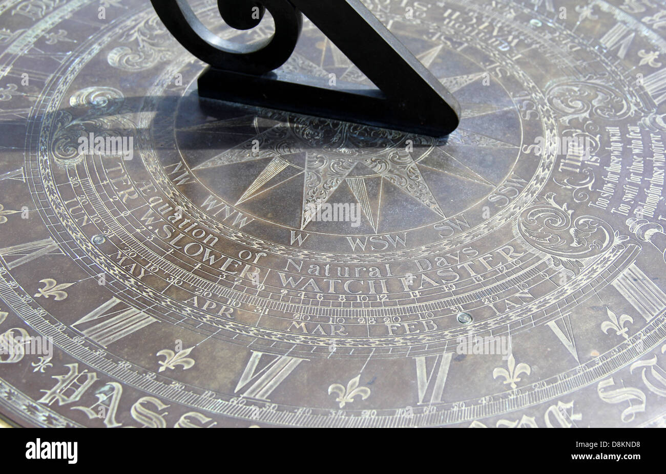 Intricate detail of sun dial used to tell time of day by black metal instrument following the path of the sun. Stock Photo