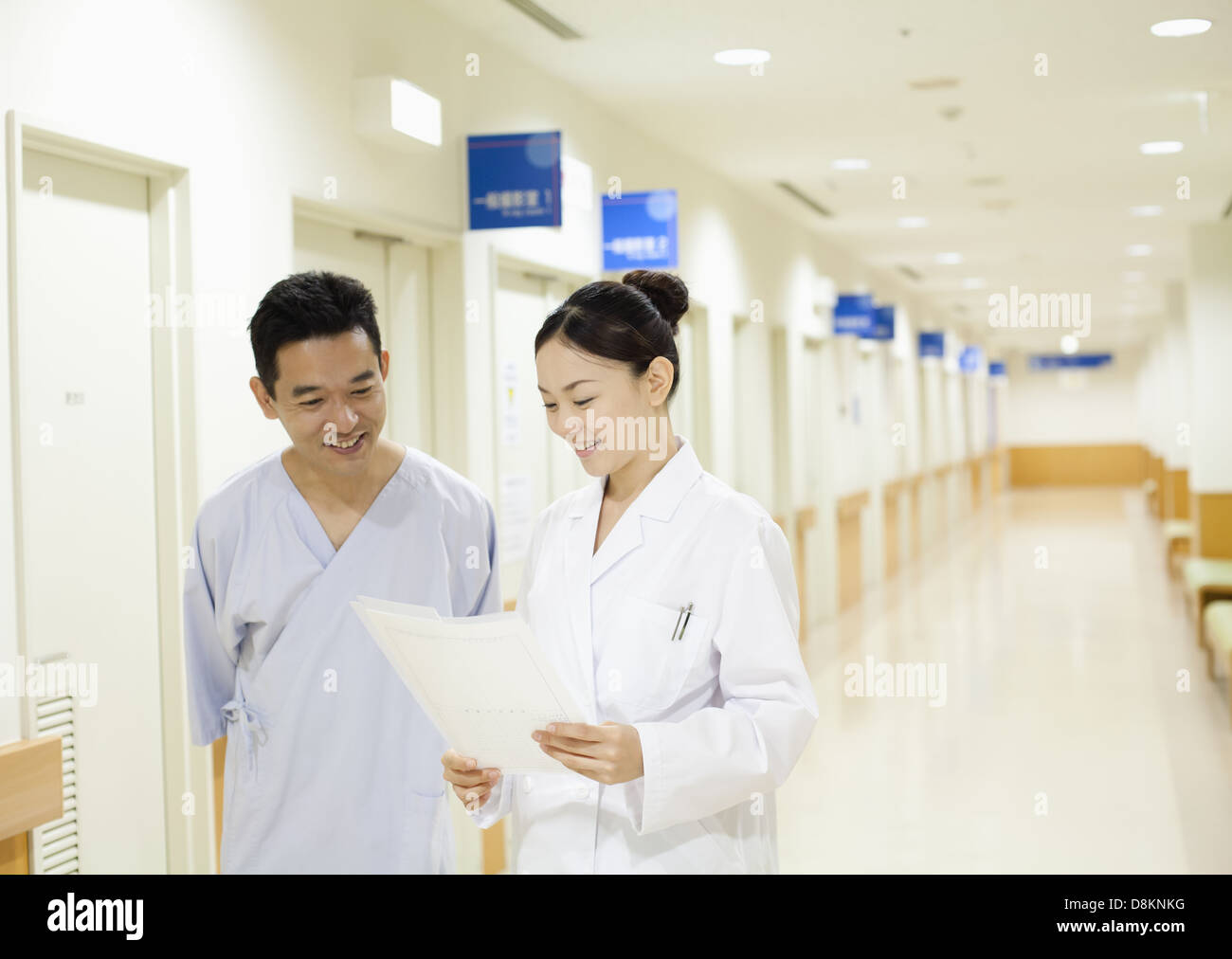 Medical technologist and a patient talking in corridor Stock Photo