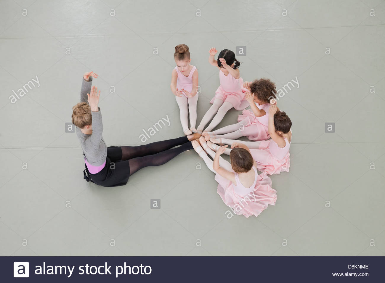 Overhead view of female ballet instructor teaching children in ballet studio Stock Photo