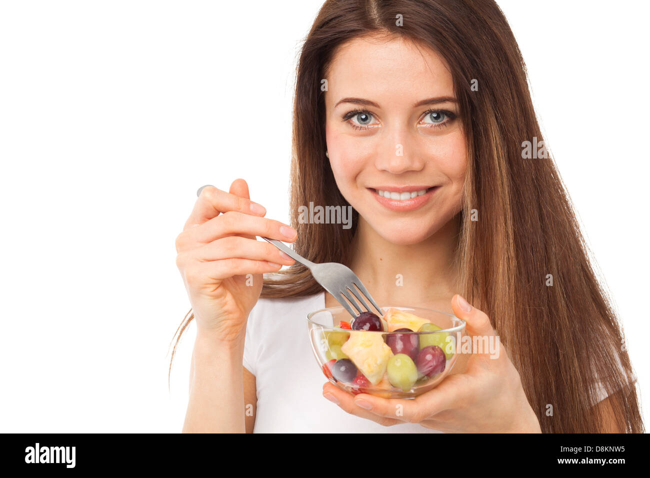 Close up portrait of a nice woman eating fruits, isolated on white Stock Photo