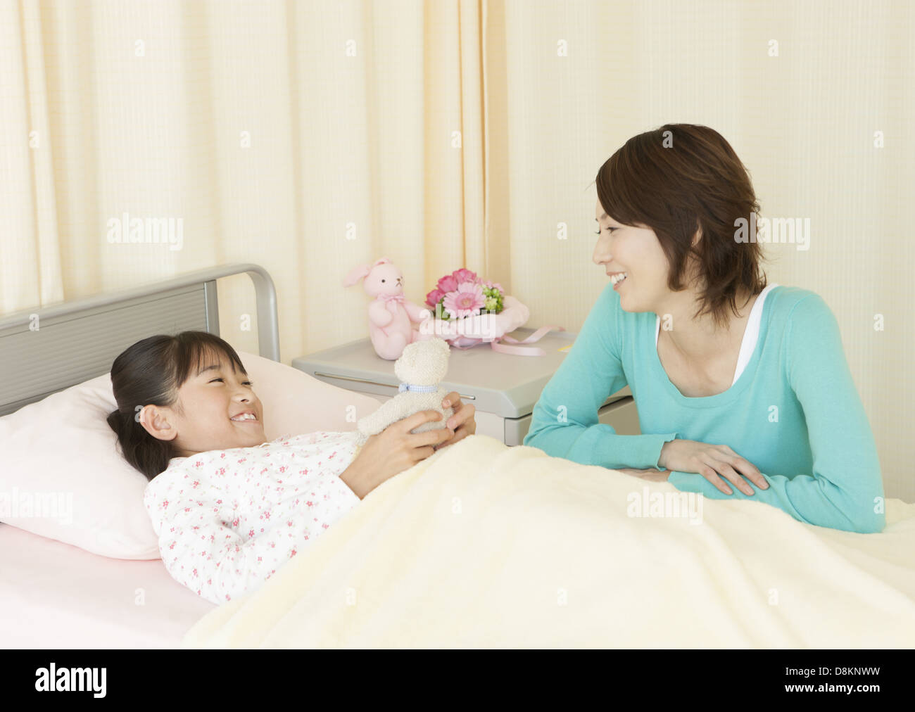 Mother and her daughter in the hospital room Stock Photo