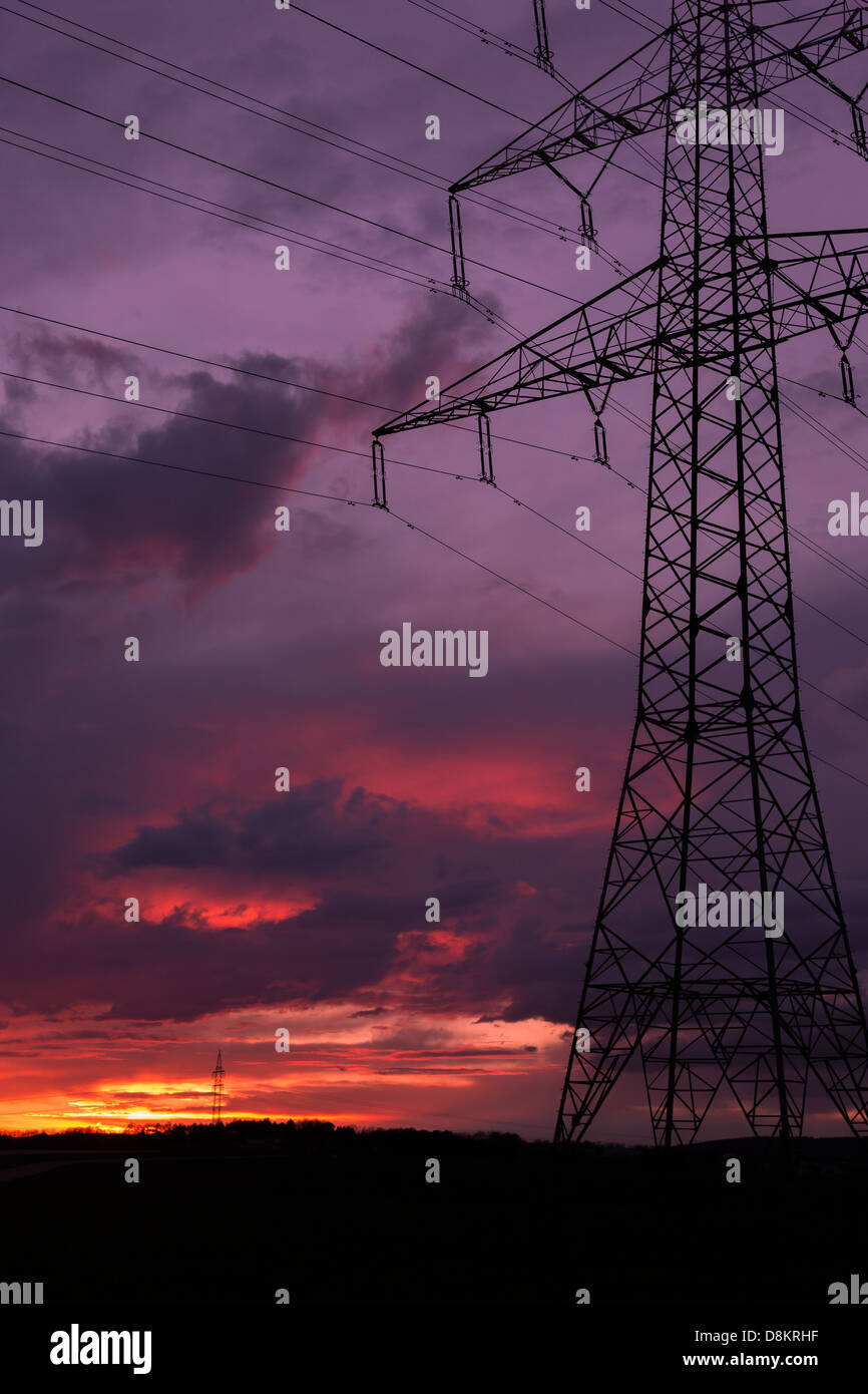 High-voltage line during purple sunset Stock Photo