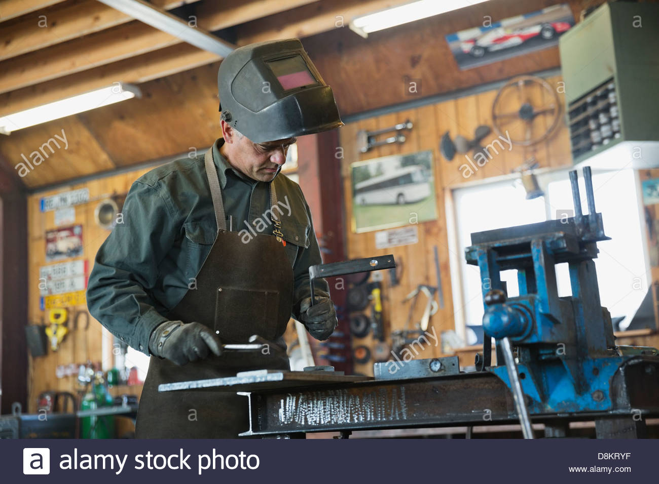 Welder in protective work wear working at workshop Stock Photo