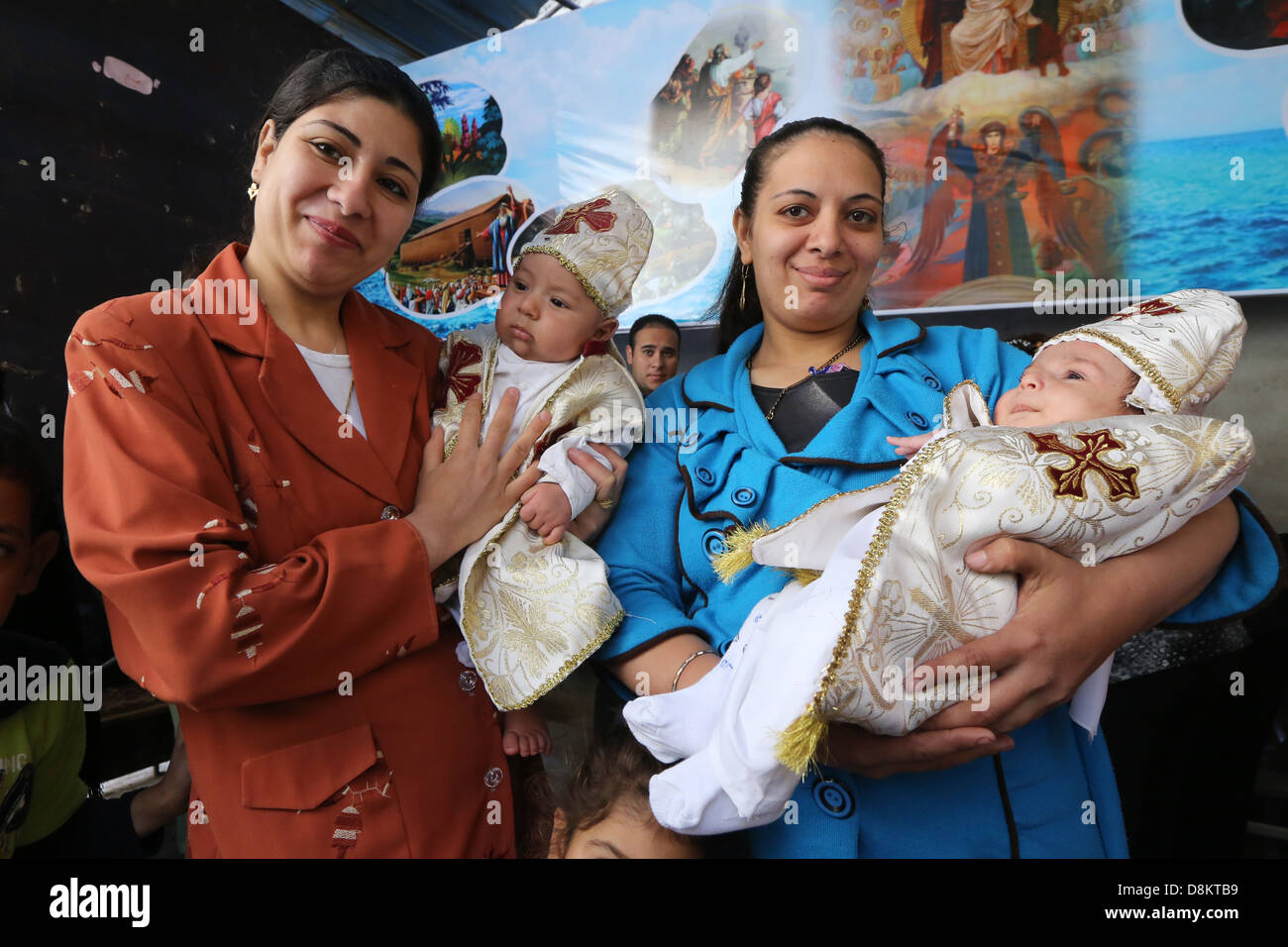 newly catholic coptic baptised babies in the arms of their mothers, Asyut diocese, Egypt. Stock Photo