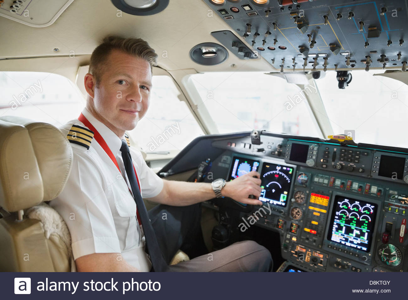 Portrait of male pilot in airplane cockpit Stock Photo