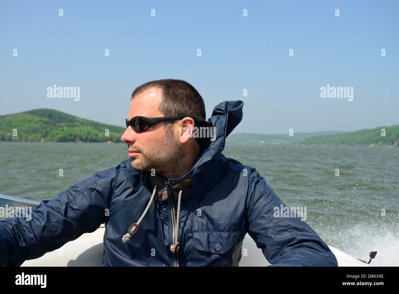 Man in a motorboat speeding away Stock Photo - Alamy