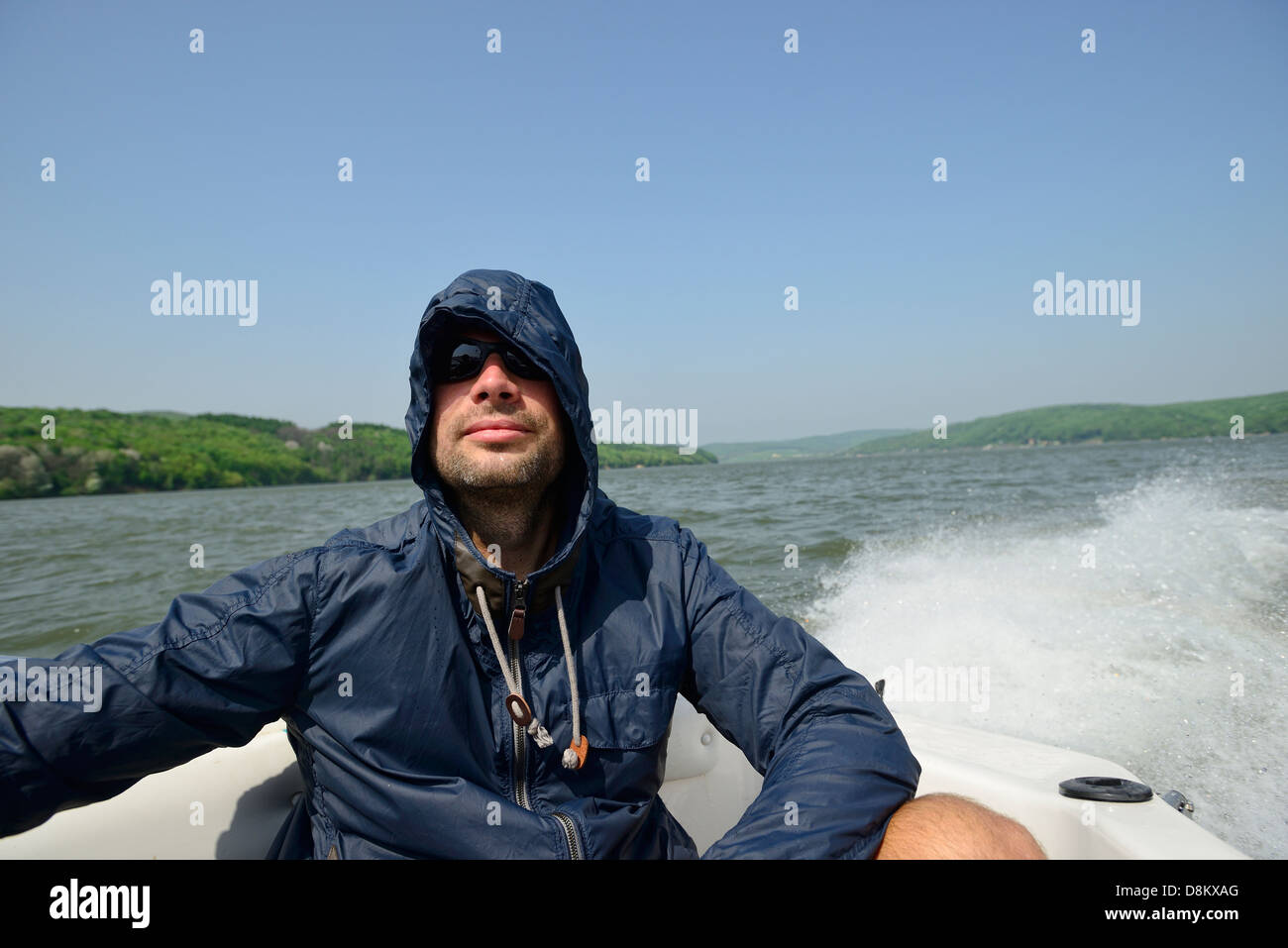 Man in a motorboat speeding away from the shores Stock Photo - Alamy