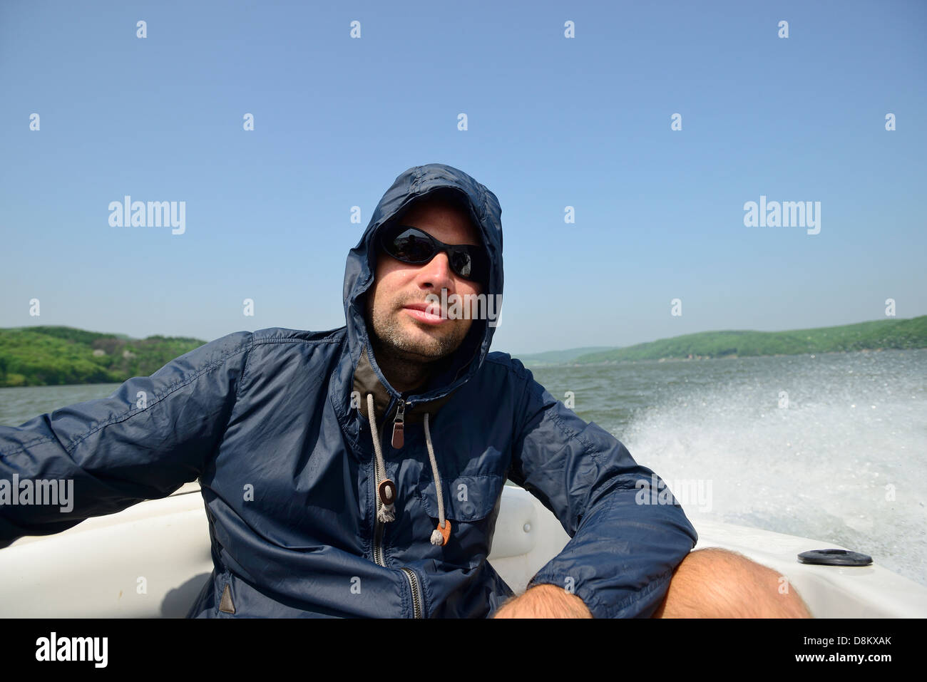 Man in a motorboat speeding away from the shores Stock Photo - Alamy