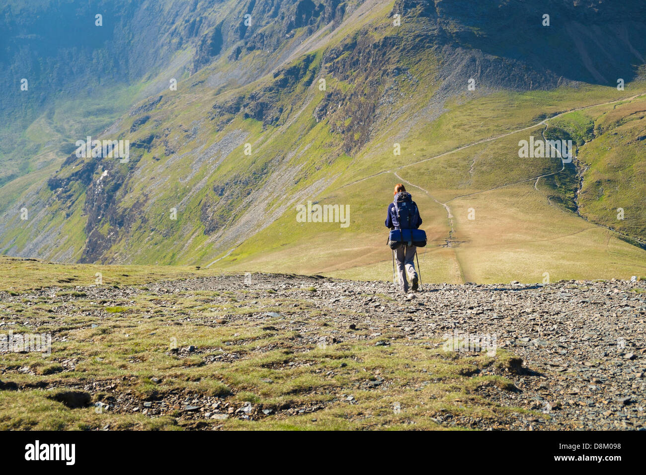 A hiker Walking down from Sand Hill to Coledale Hause in the Lake District Stock Photo