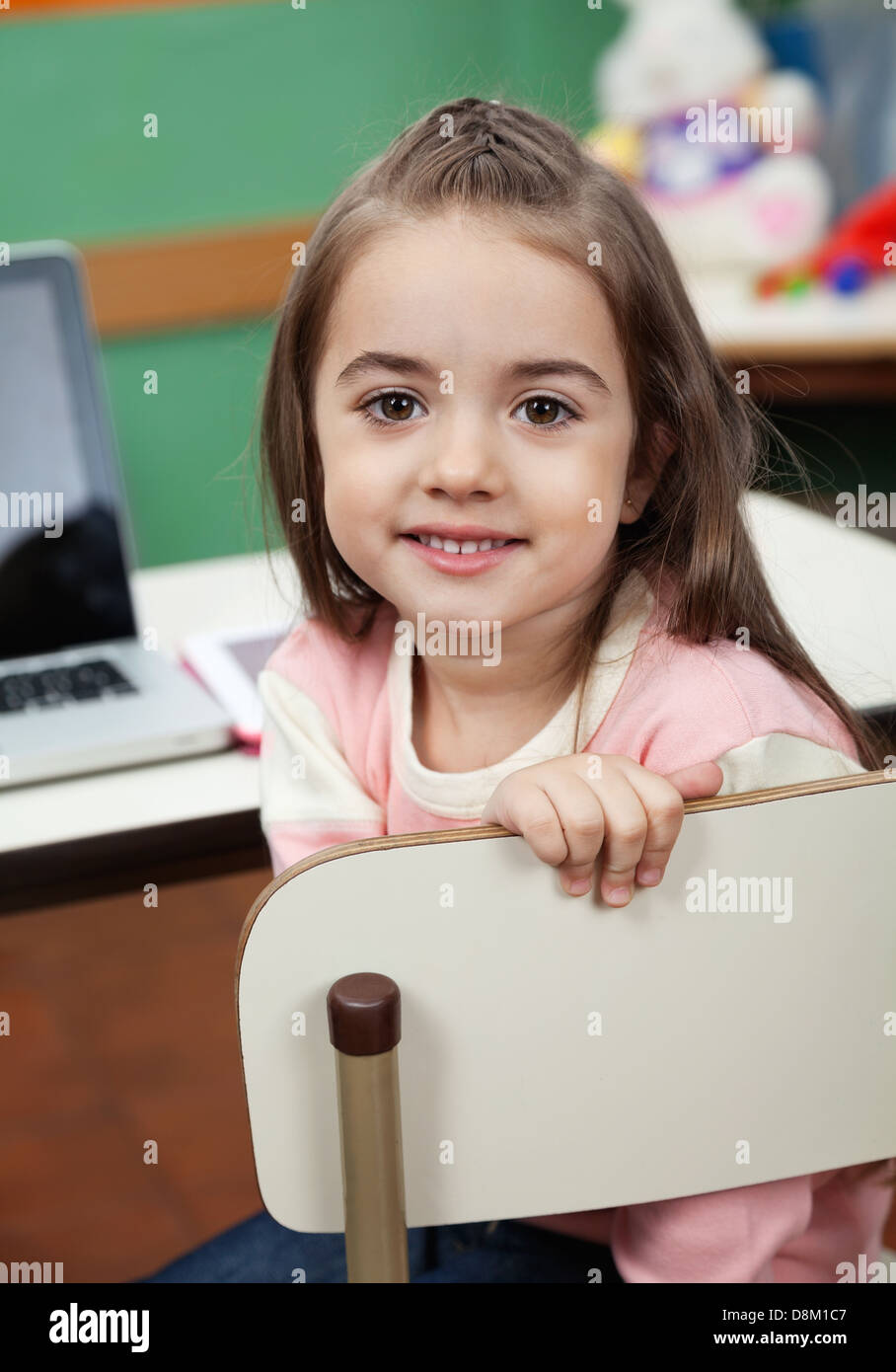 Girl Sitting On Chair With Laptop On Desk In Classroom Stock Photo Alamy
