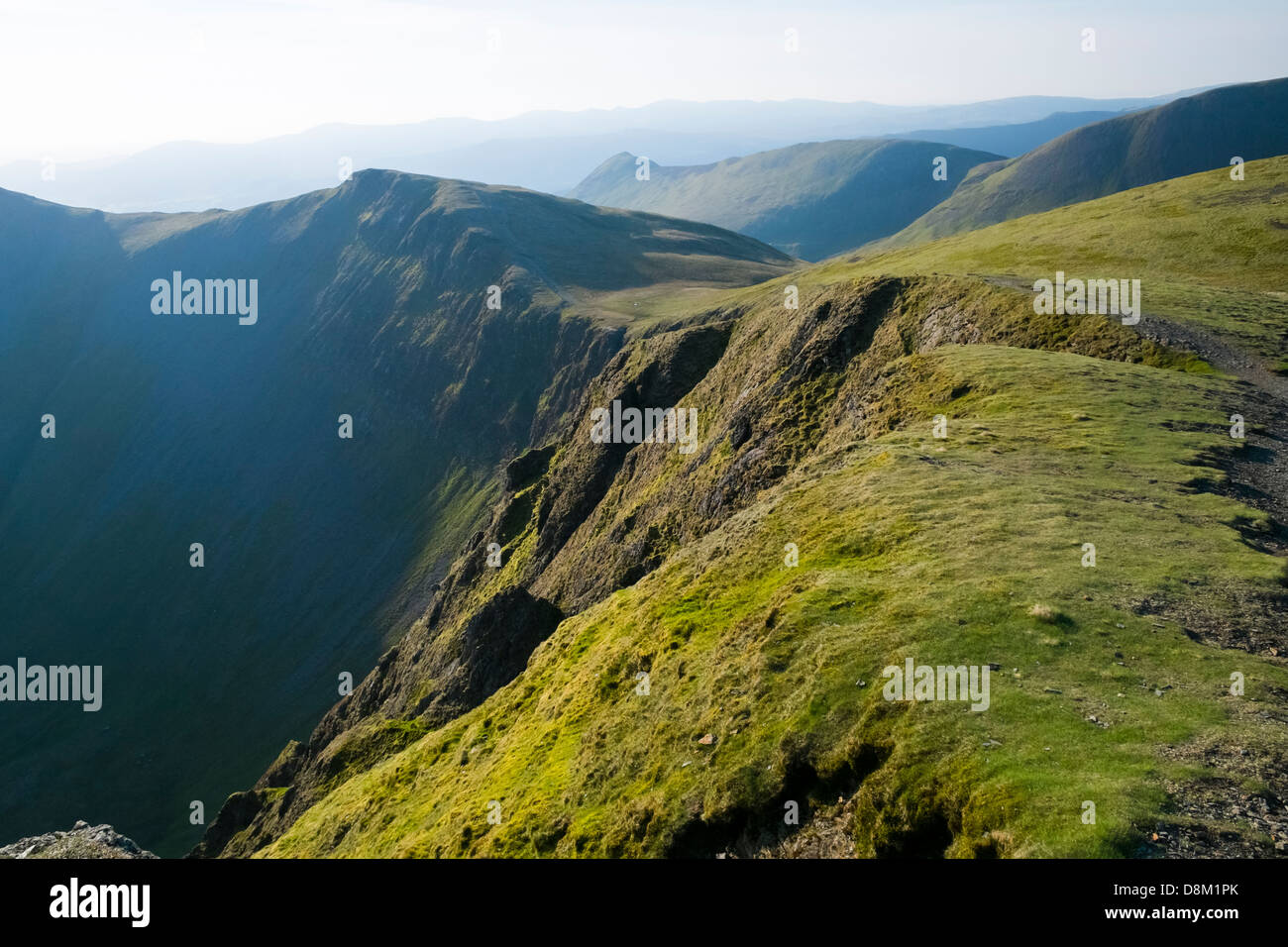 Looking towards Hobcarton Crags from the summit of Hopegill Head at sunrise in the Lake District Stock Photo