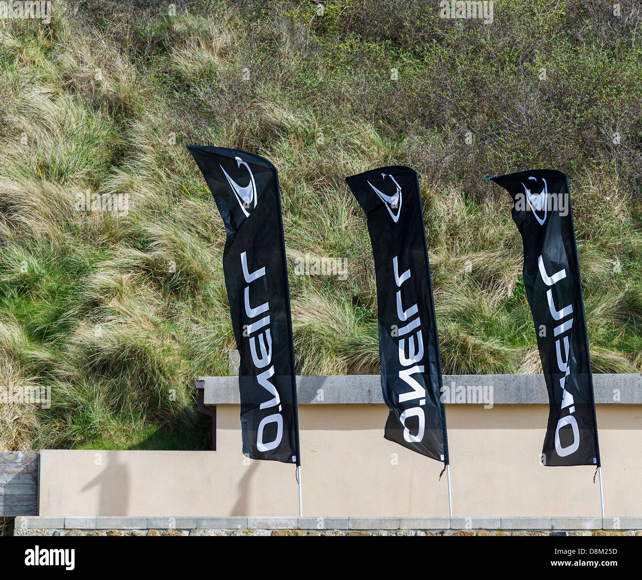 Three flags advertising the firm ONeill. Stock Photo