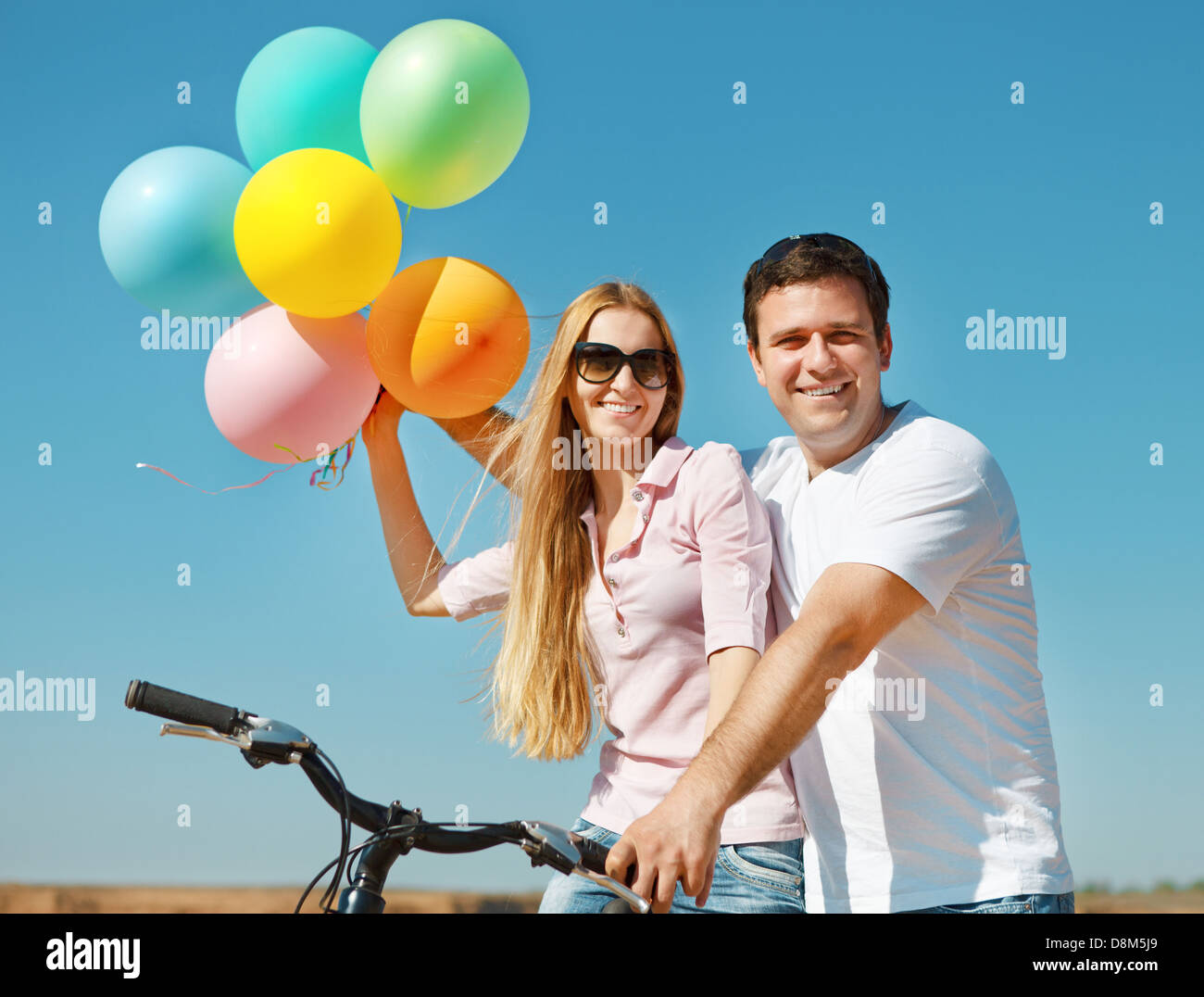 Happy smiling couple with balloons Stock Photo - Alamy