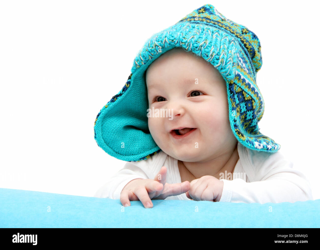 happy baby in knitted hat on stomach Stock Photo