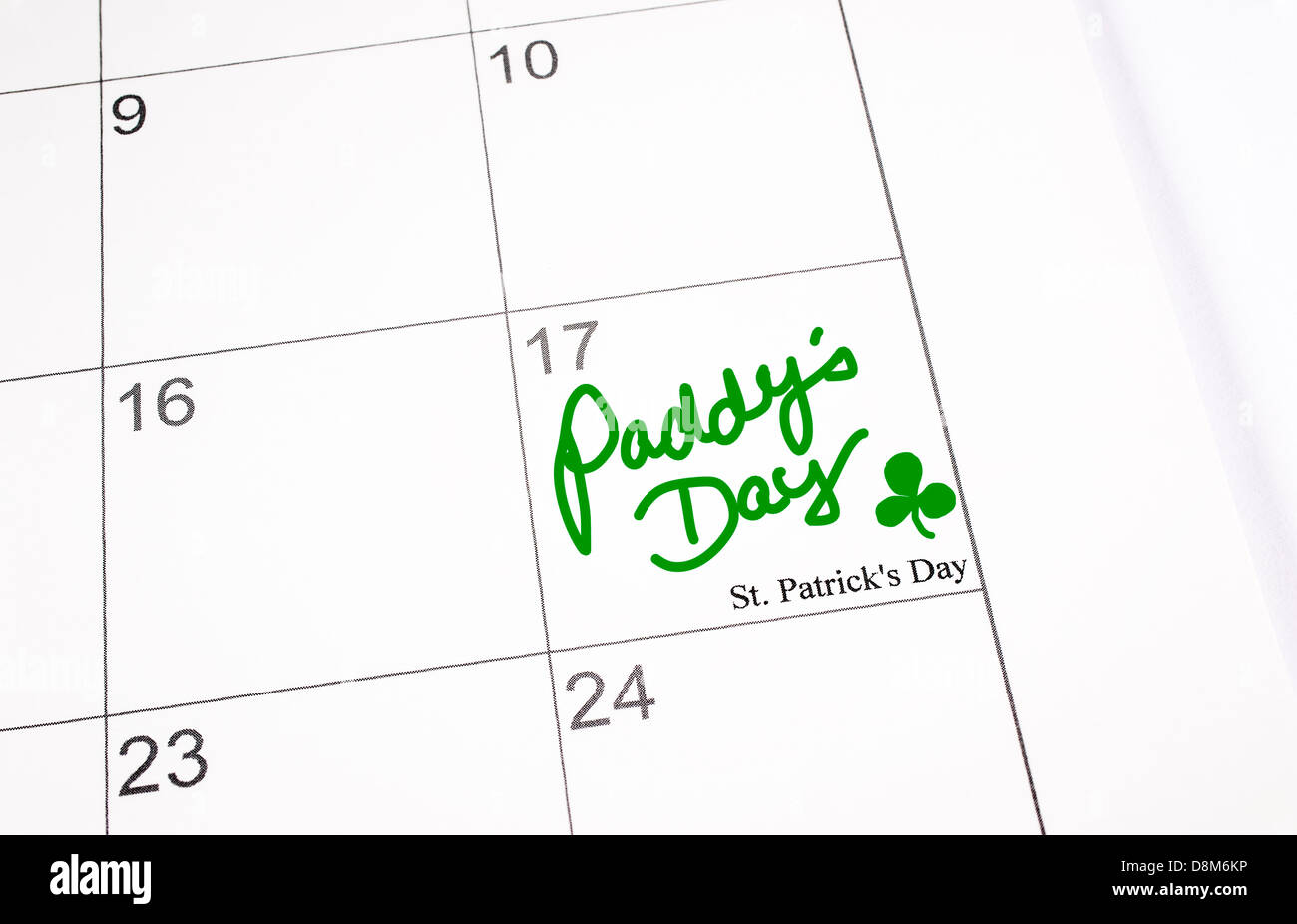 A calendar page showing 17th March, Saint Patrick's day. Paddy's Day written in green ink Stock Photo