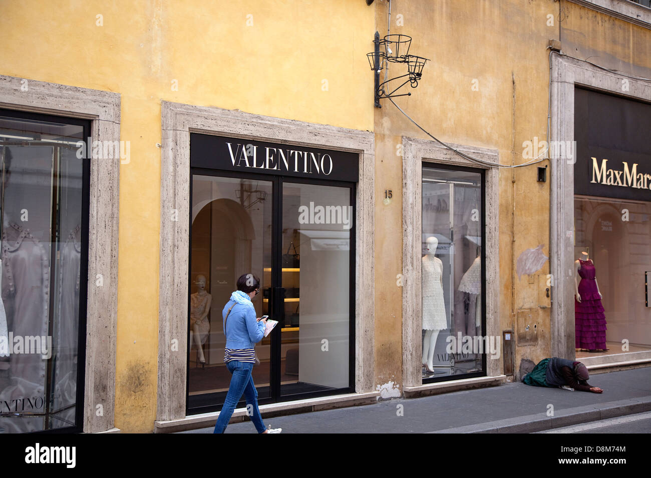 Italy, Lazio, Rome, Via del Condotti, Exterior of the designer clothing shop with begging outside Stock Photo - Alamy