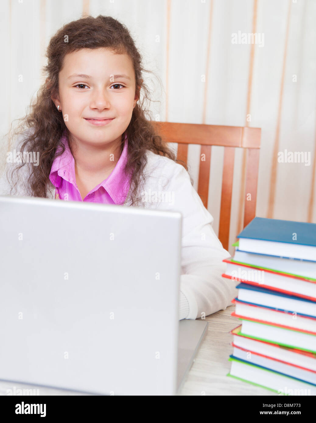 Little brunette smiling girl with laptop Stock Photo - Alamy