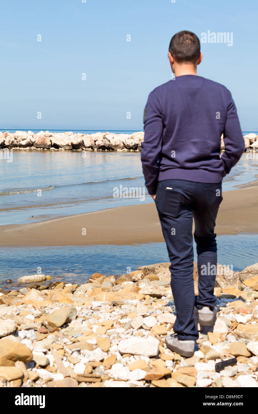 Man On The Beach Watching Over Horizon Stock Photo