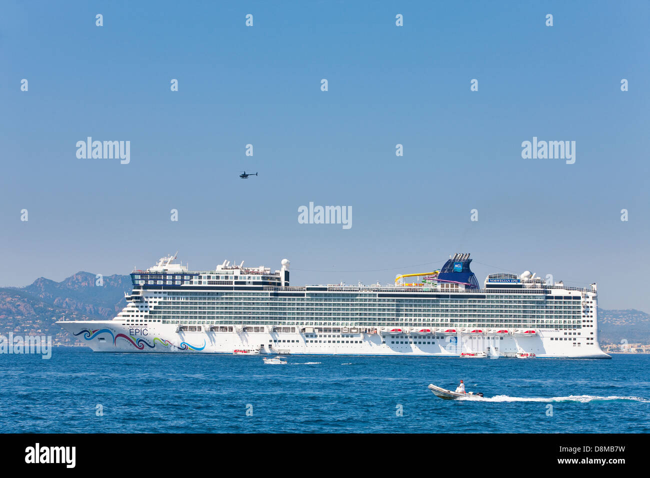 Helicopter over the Norwegian Epic in the bay of Cannes, France Stock Photo