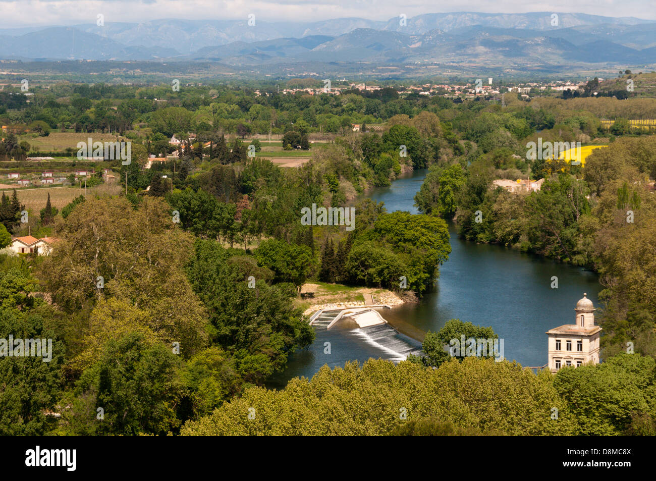 The River Orb at Beziers in southern France, with the hills of the High Languedoc in the background. Stock Photo