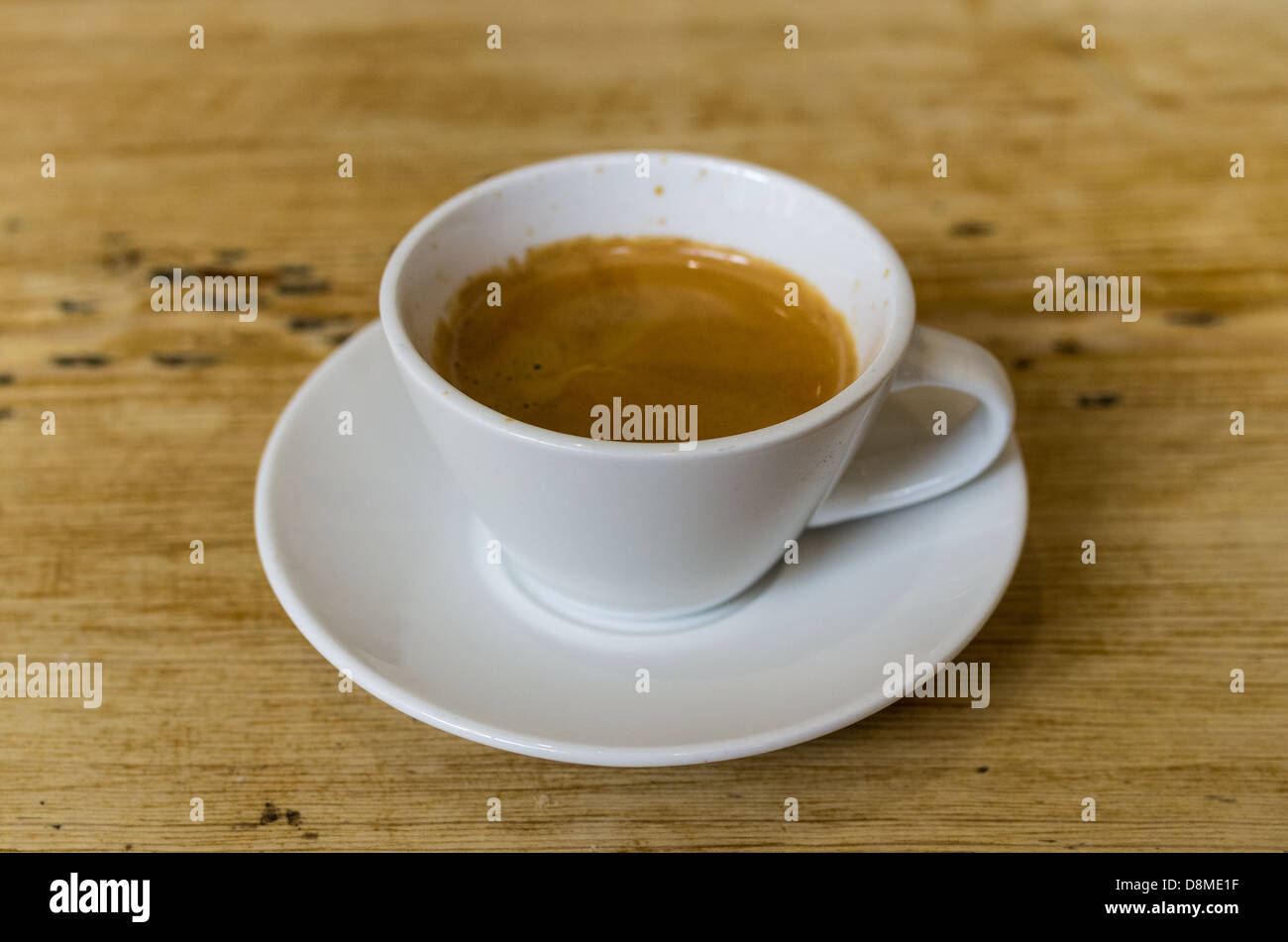 A cup of coffee on a wooden table Stock Photo