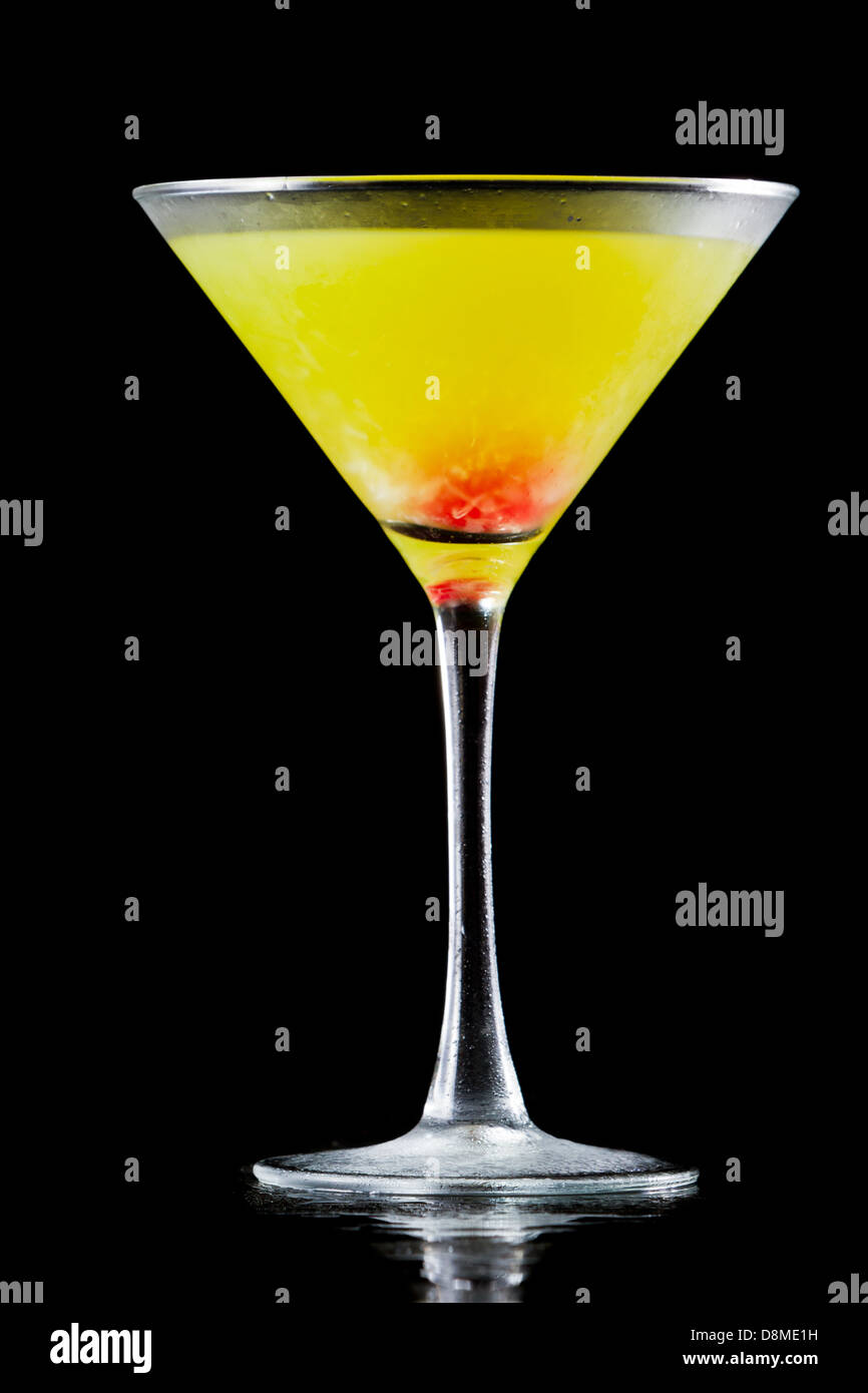 mellon ball cocktail served in a martini glass isolated on a black background Stock Photo
