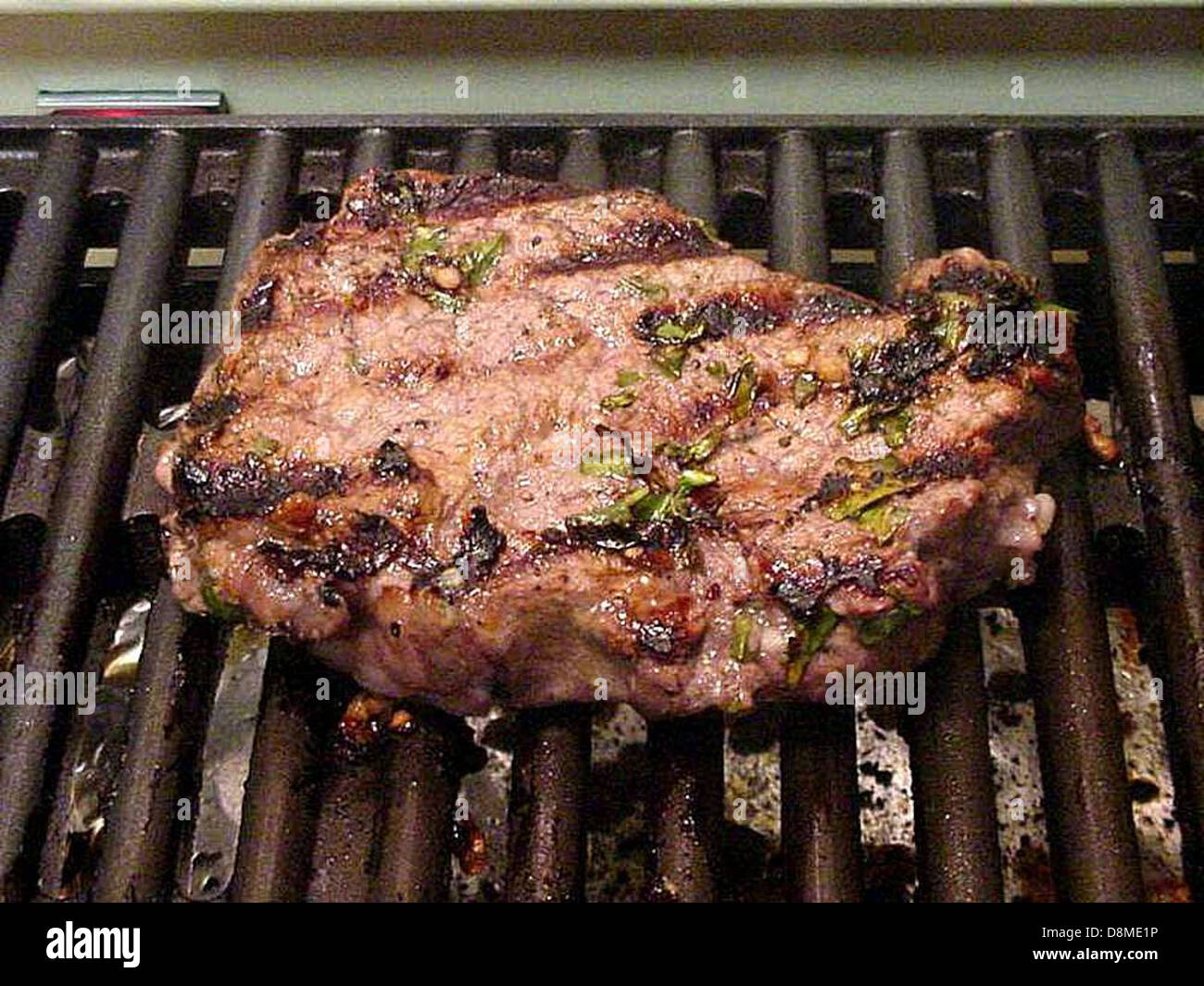 Marinated steak on grill Stock Photo Alamy
