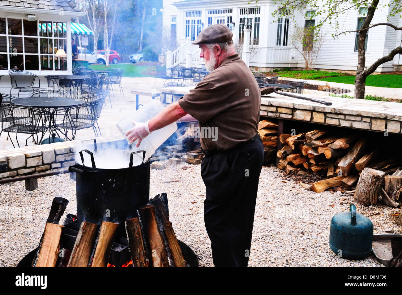 Fish is added to a large pot during a traditional Wisconsin fish boil at the White Gull Inn in Fish Creek Stock Photo