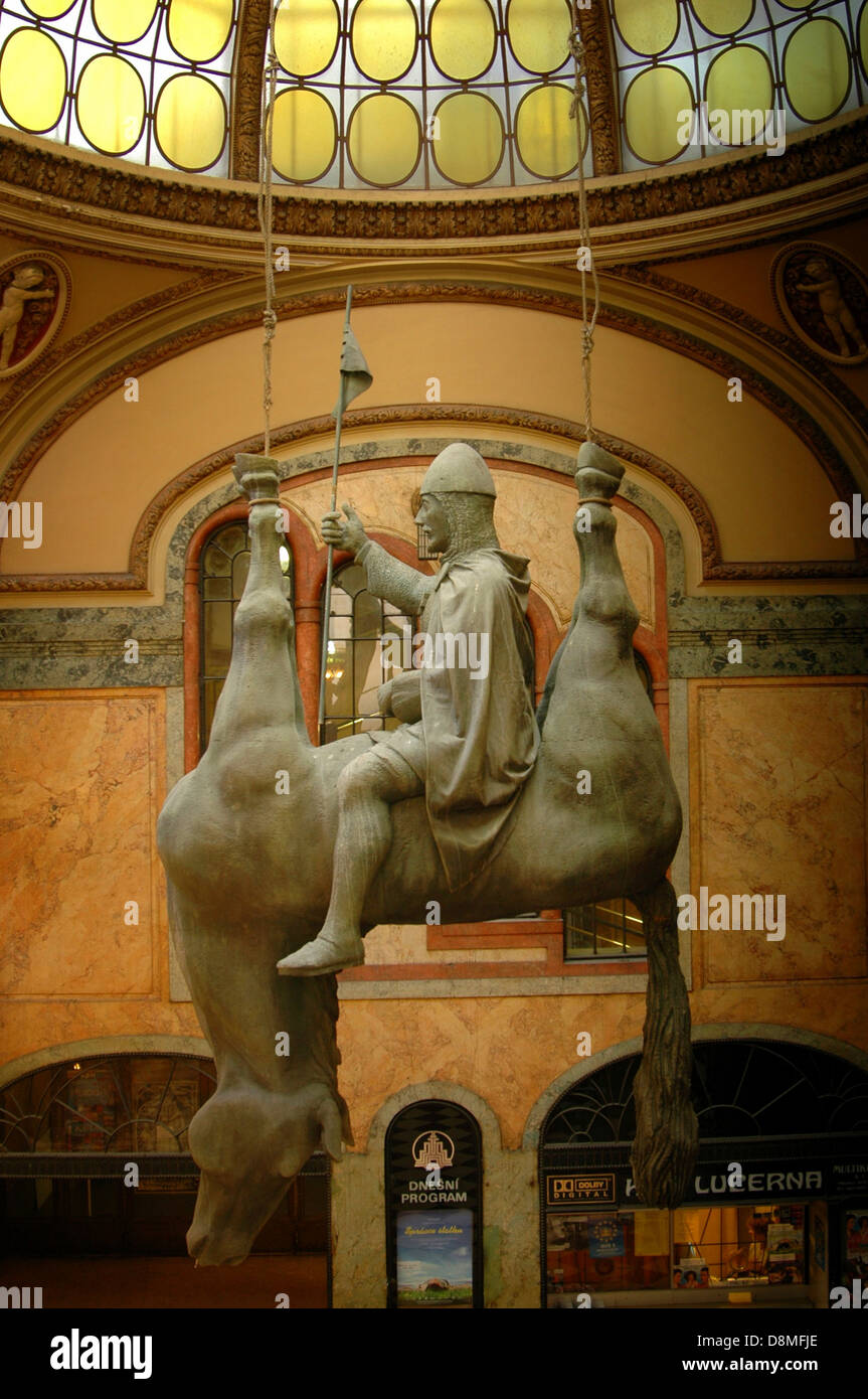 Cerny's 1999 “Horse” portrays Saint Wenceslas (Vaclav) on an upside-down dead horse as a parody of the Czech patron saint who had been a heroic duke of Bohemia and was assassinated in 935 displayed inside Lucerna Passage in Nove Mesto district in Prague Czech republic Stock Photo