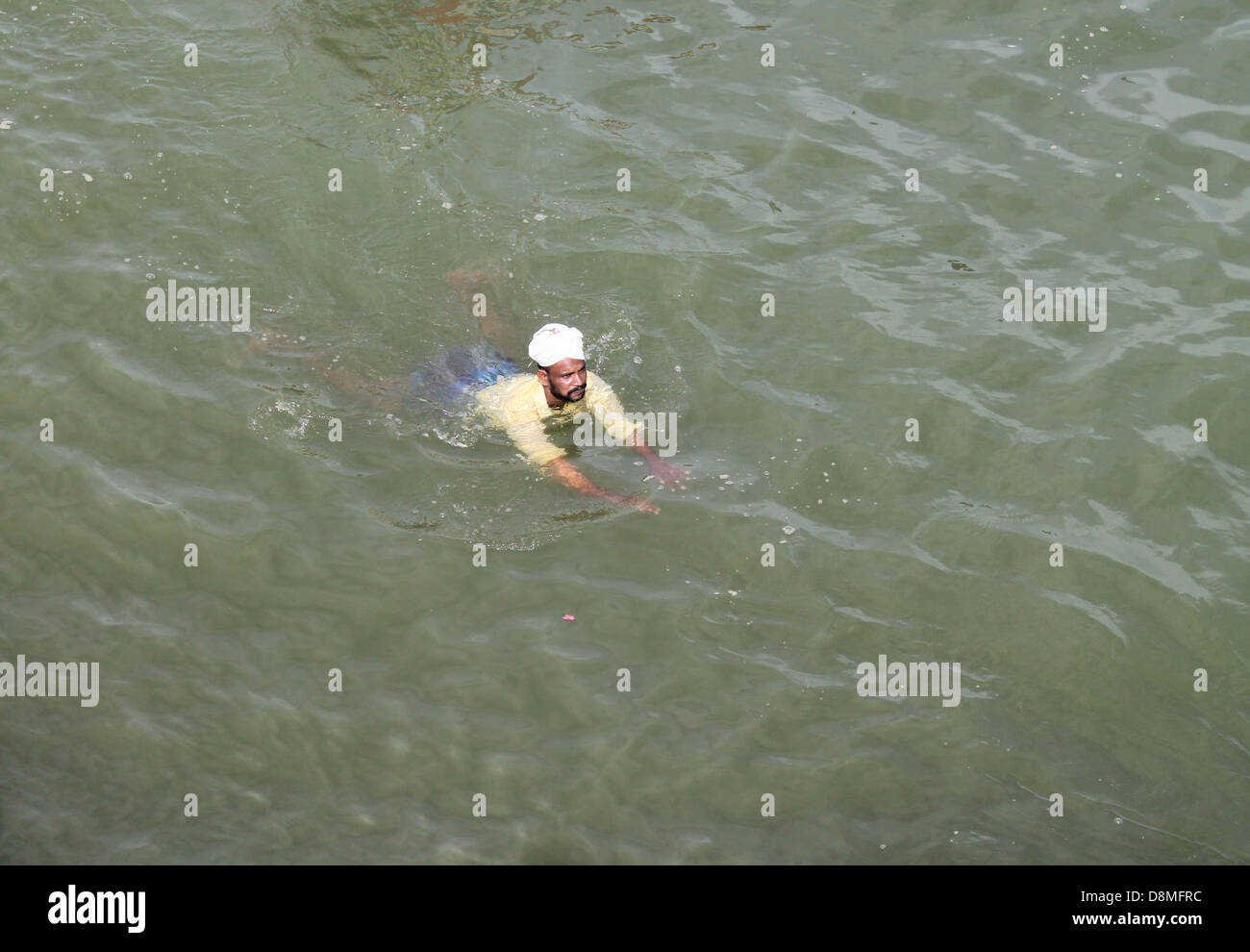 An Indian fisherman swimming in the sea Stock Photo