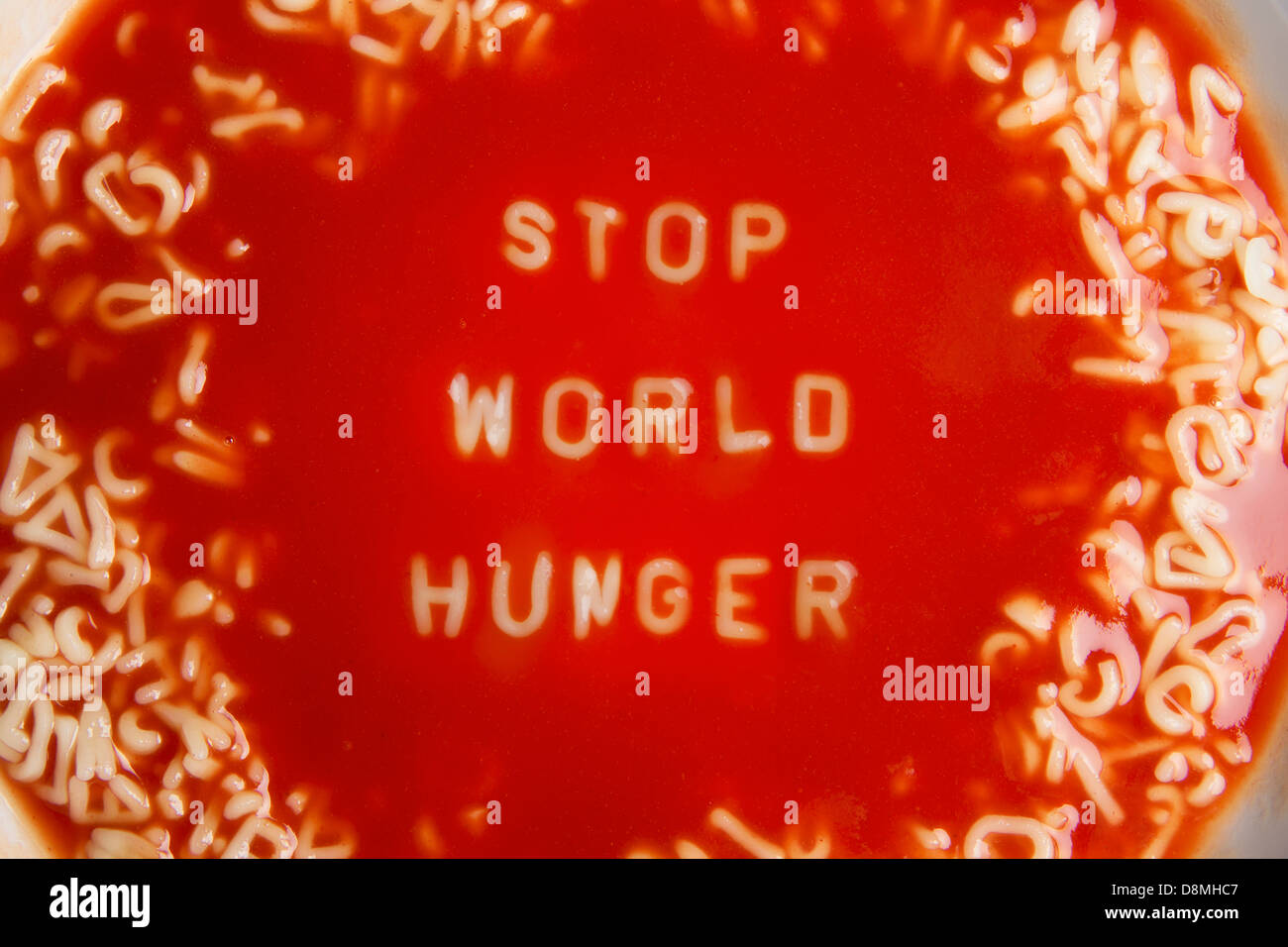 tomato soup with noodle letters message "stop world hunger" Stock Photo