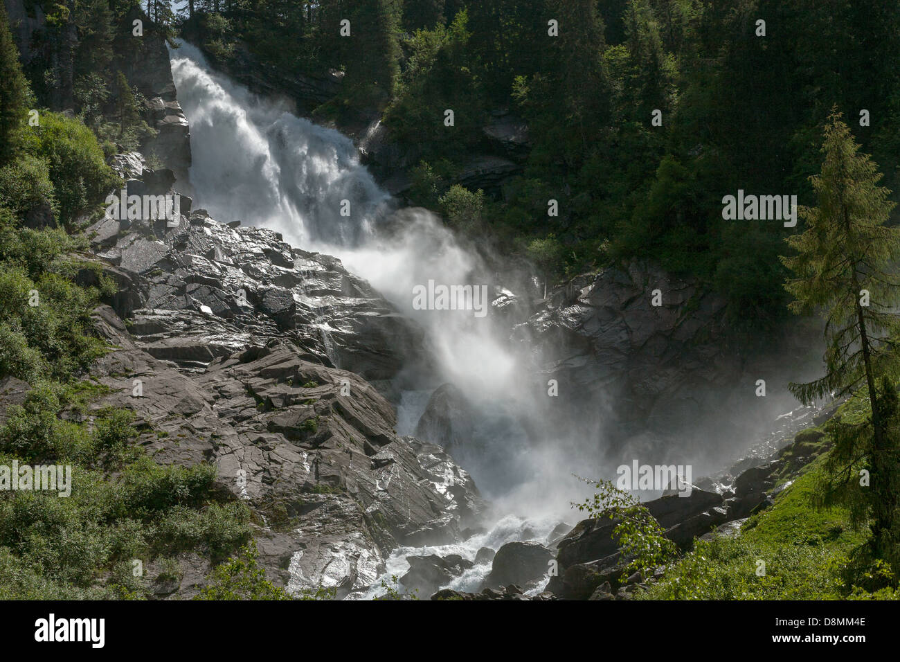 The upper waterfall at Krimml Falls, the highest waterfalls in Austria and Central Europe, Krimml, Salzburg, Austria. Misty spray with sun behind. Stock Photo