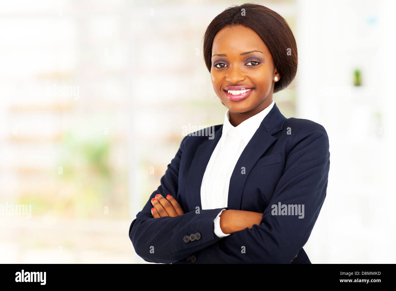 pretty African American businesswoman half length portrait in office ...