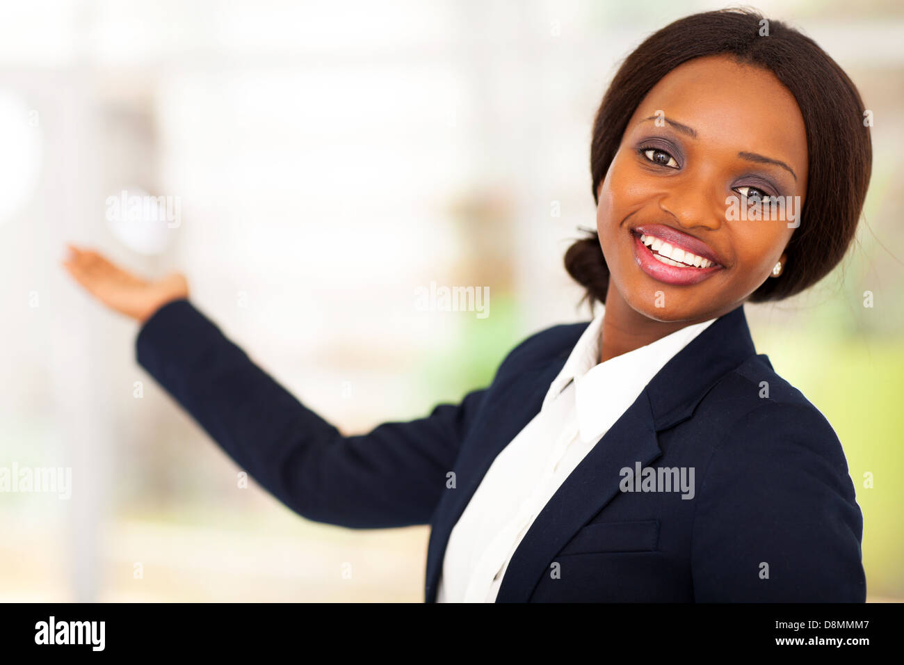 cheerful African American businesswoman presenting Stock Photo - Alamy