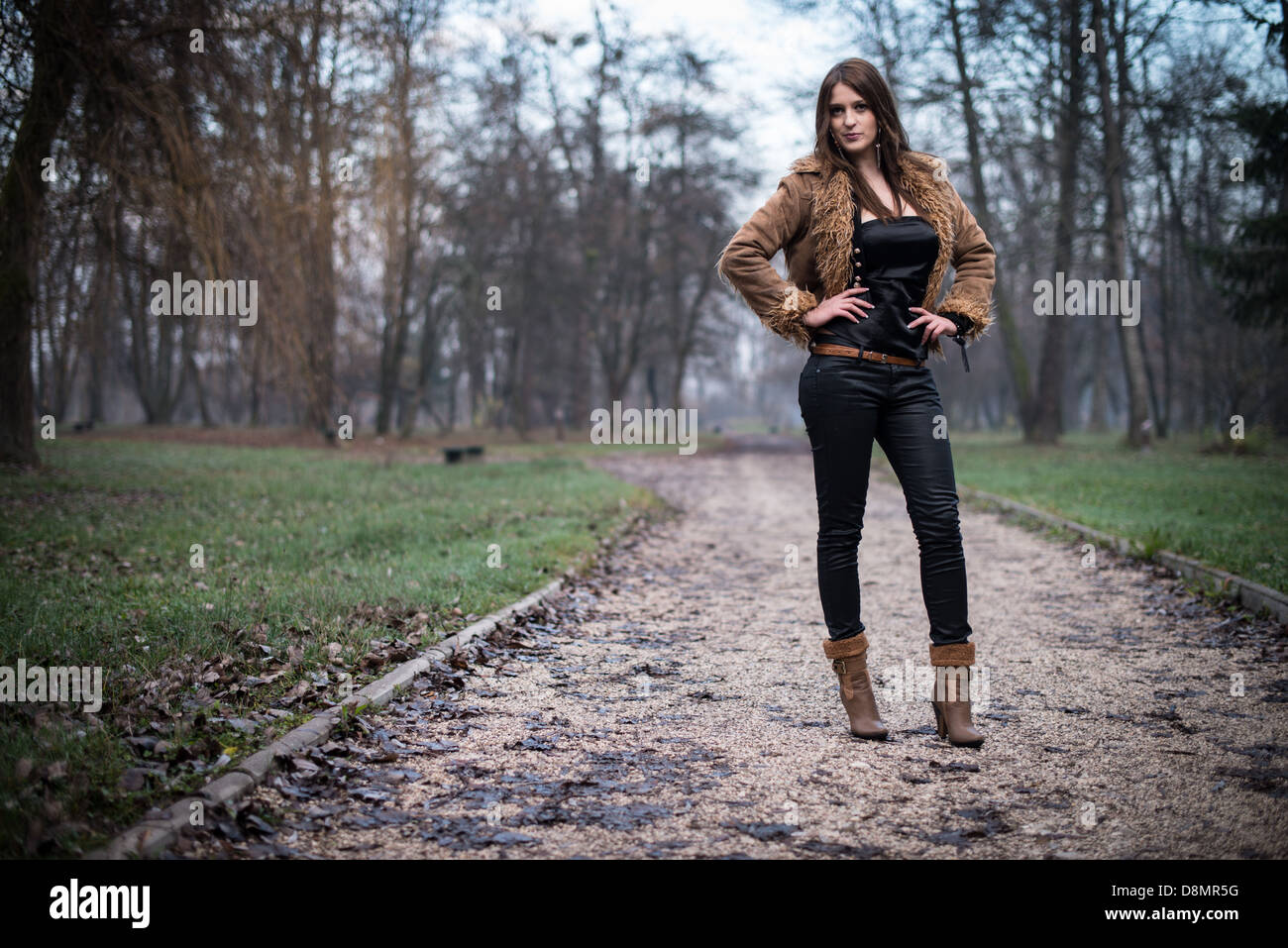 young woman in jacket standing and posing at the forest Stock Photo - Alamy