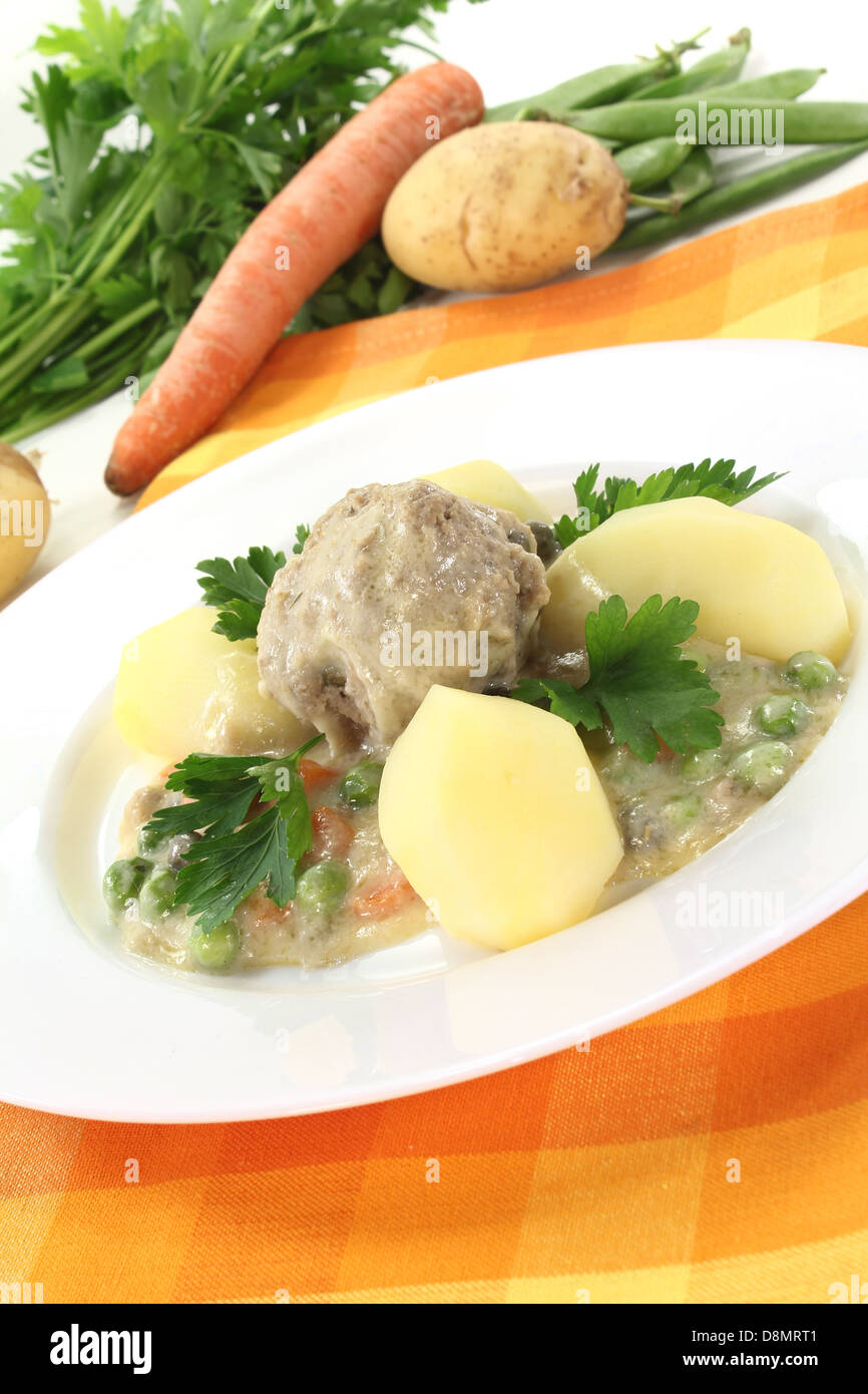 cooked meatballs in a white sauce with capers Stock Photo