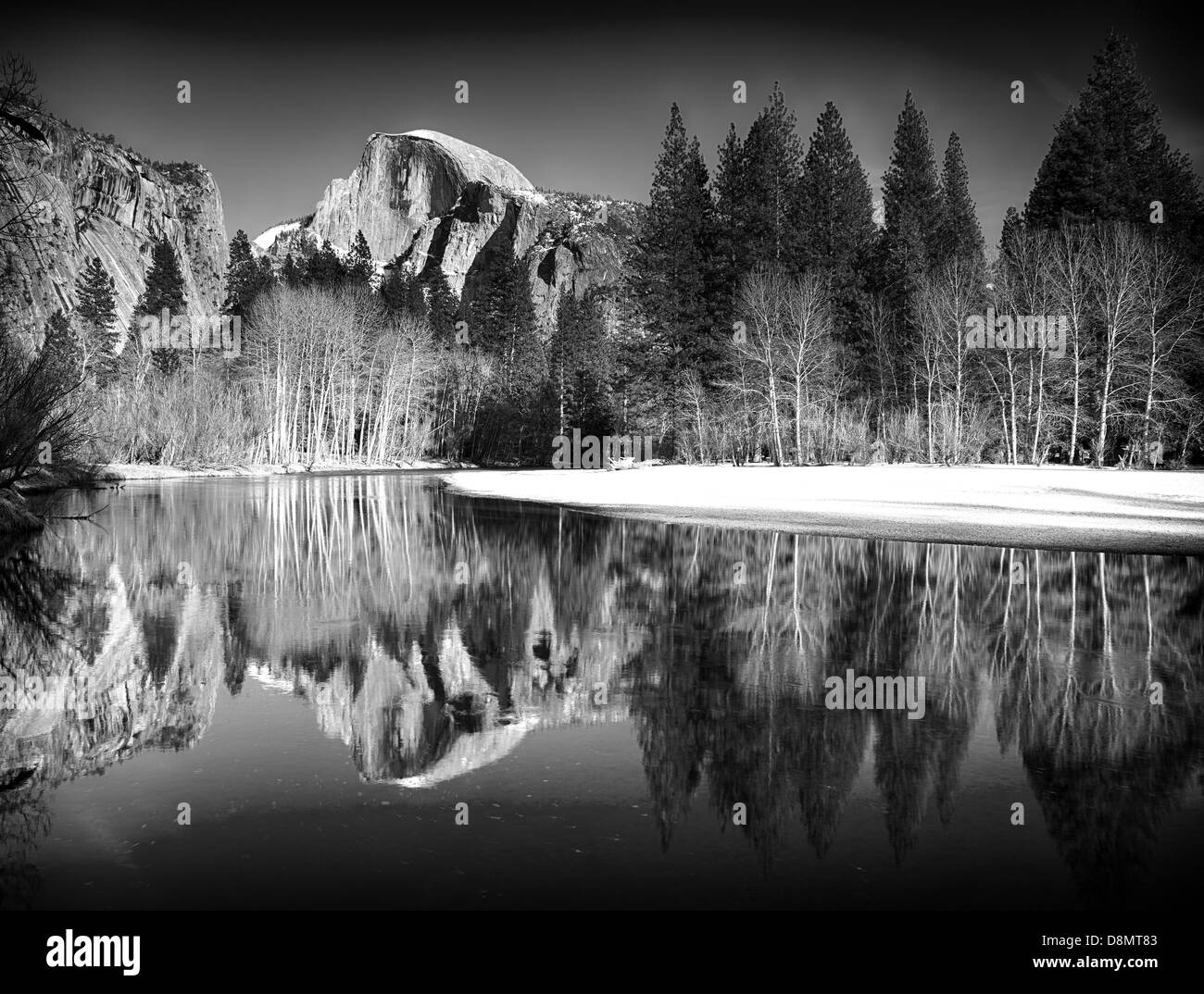 Black and white view of half dome reflected in the Merced river at Yosemite National Park Stock Photo