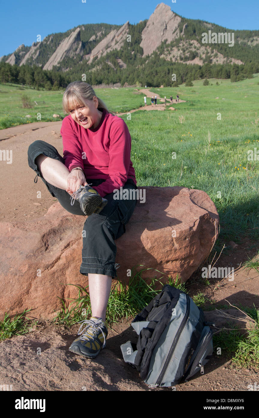 Woman rubbing hurt ankle. Stock Photo