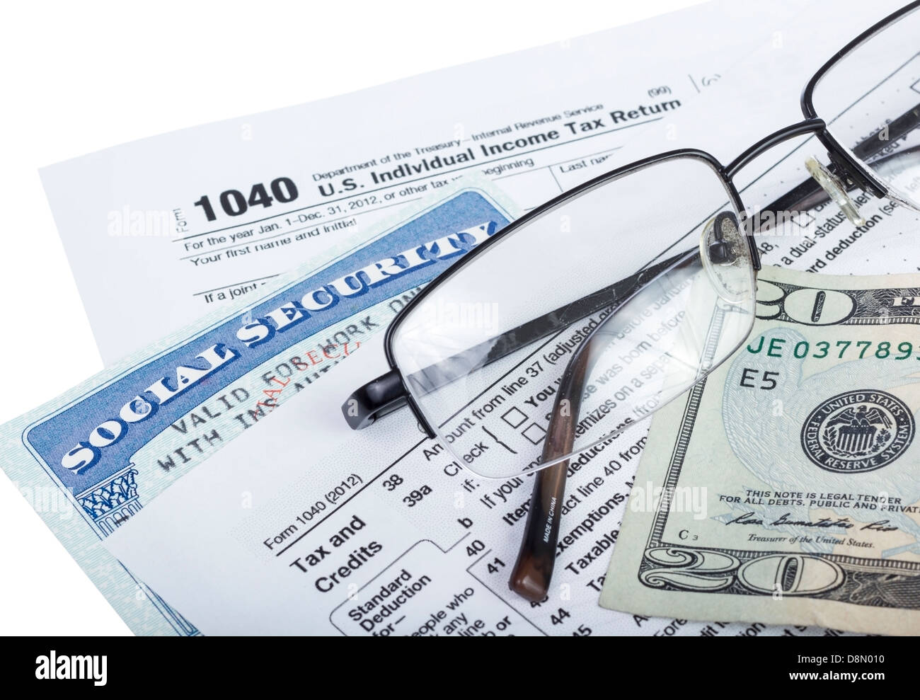 American federal tax form 1040 with money and social security card isolated on white. Stock Photo