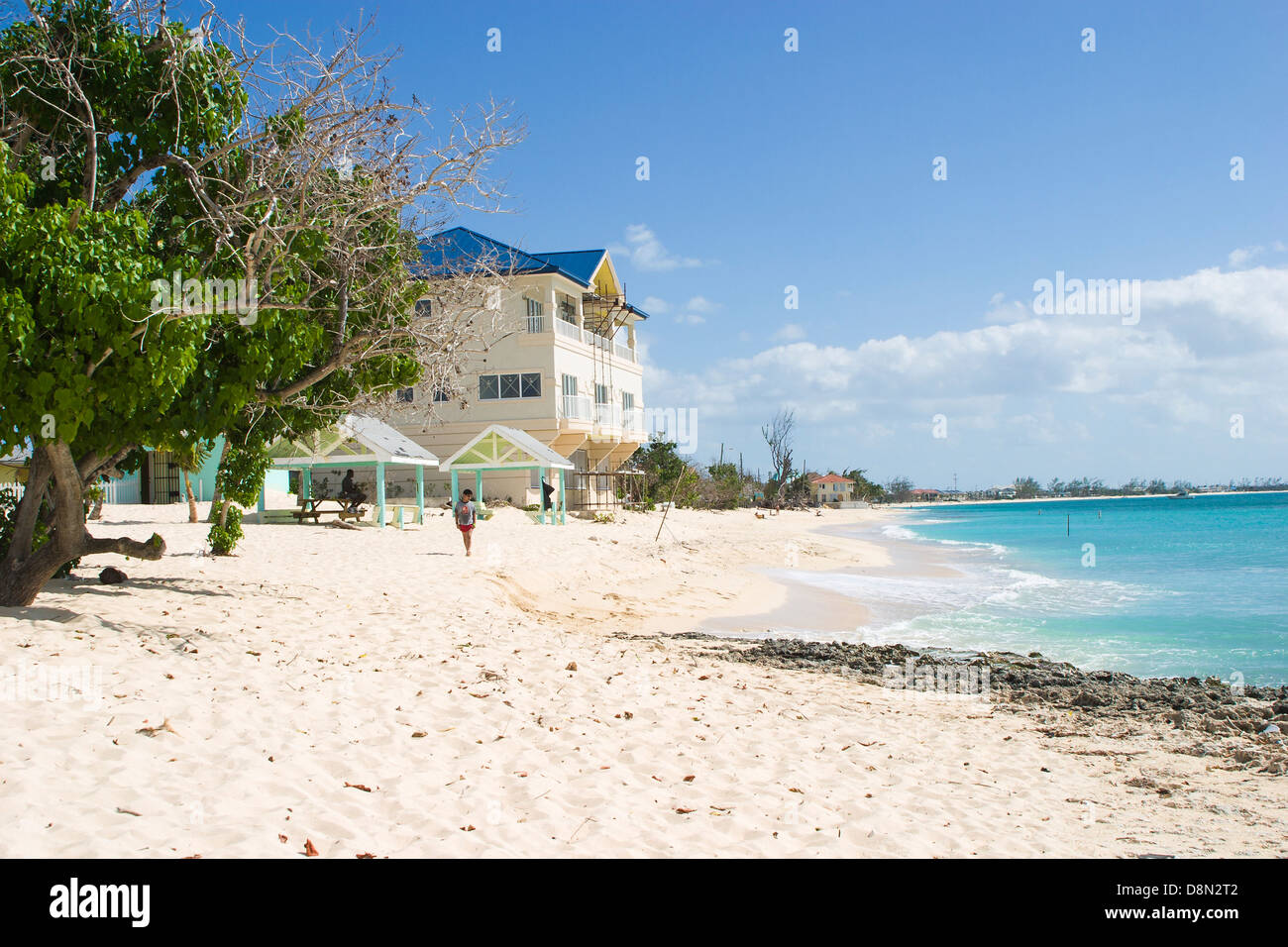 White sand beach under a blue sky with an azure sea in glorious summer weather on Grand Cayman, Caribbean Stock Photo