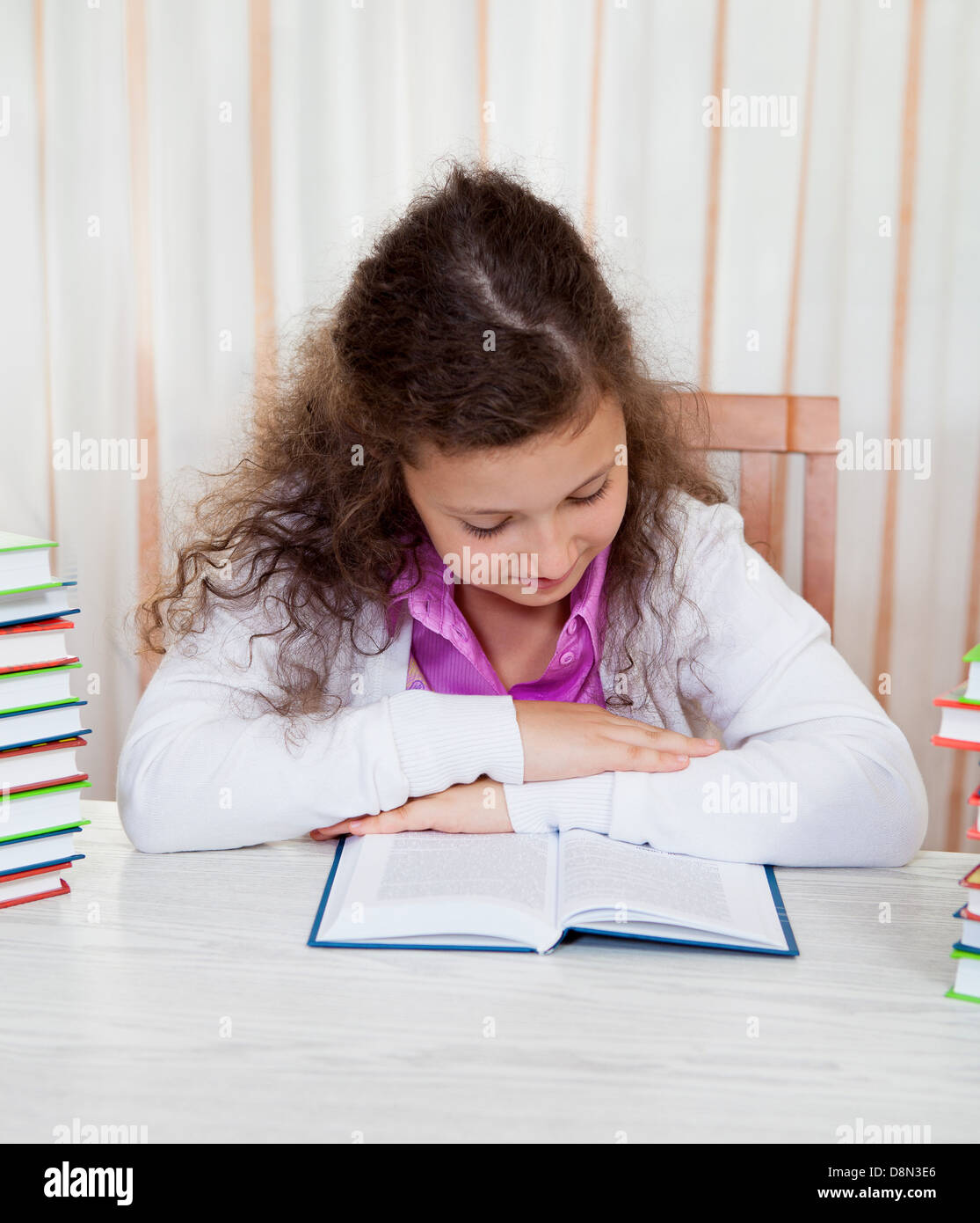 Little girl with piles of books Stock Photo - Alamy