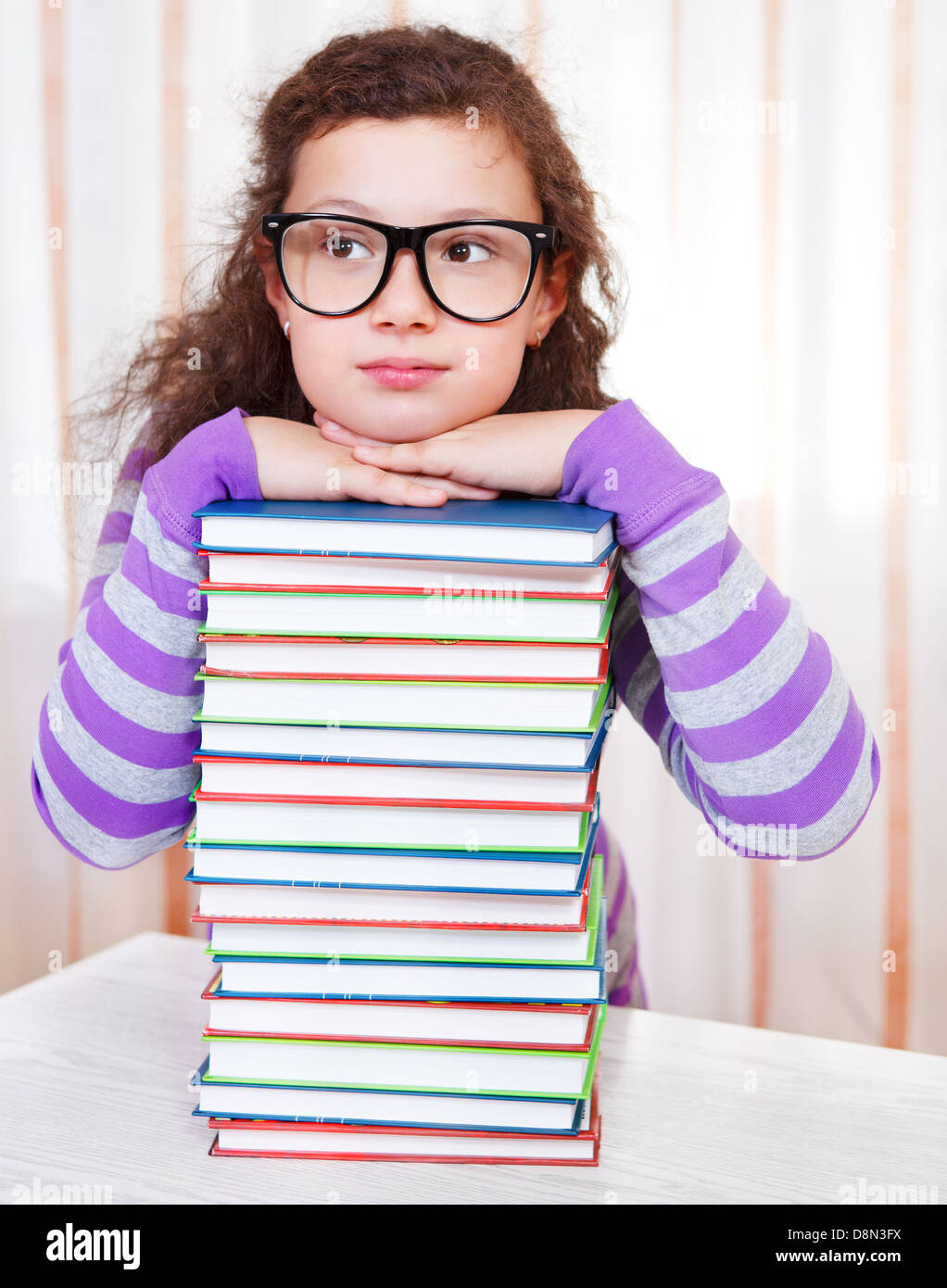Little girl with pile of books Stock Photo - Alamy
