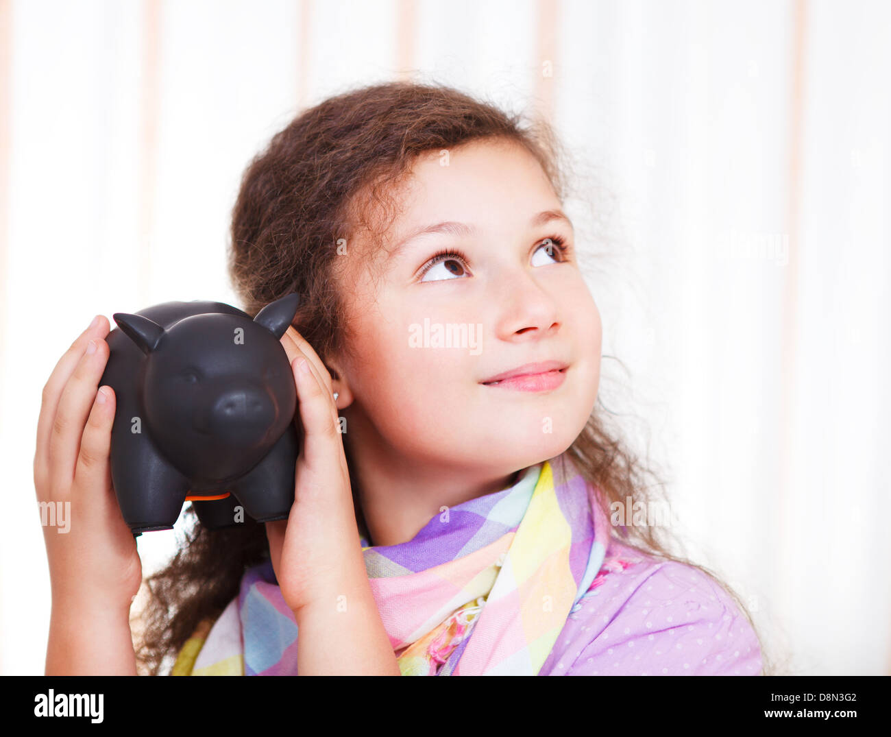 Little girl saving money in a piggybank Stock Photo - Alamy