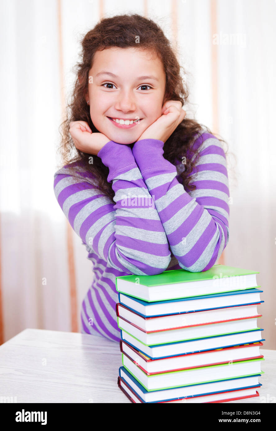 Girl with pile of books hi-res stock photography and images - Alamy