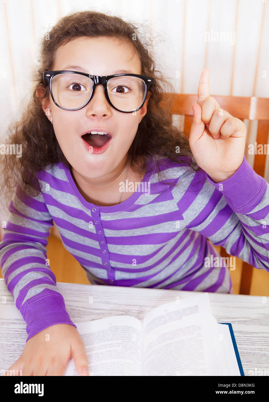 Little brunette smiling girl with book Stock Photo - Alamy
