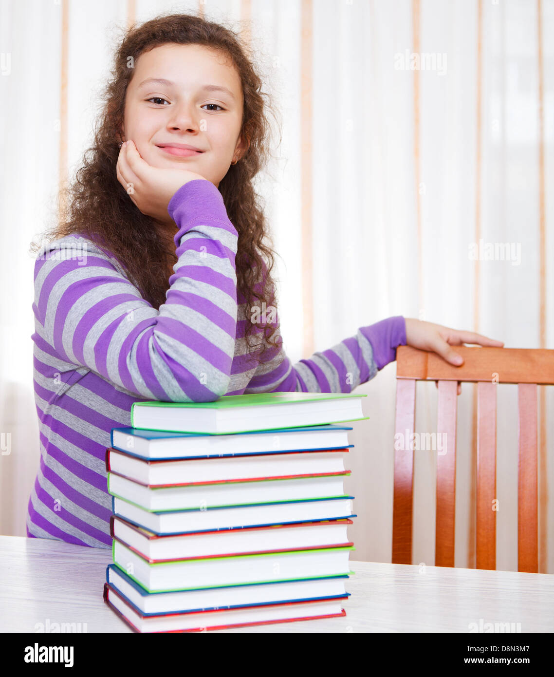 Little brunette smiling girl with of books Stock Photo - Alamy
