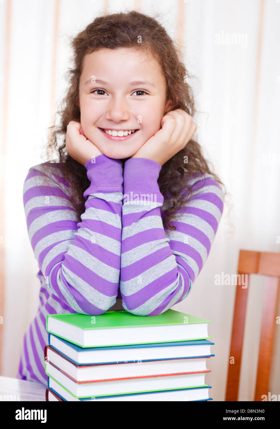 Little brunette smiling girl with books Stock Photo - Alamy