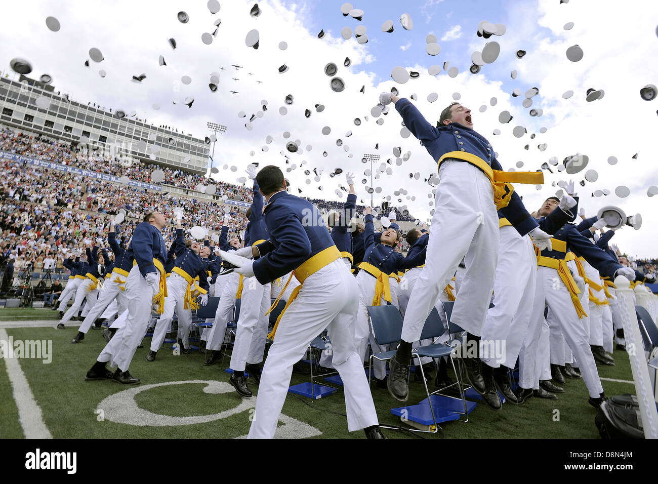 Newly minted second lieutenants of the US Air Force Academy Class of 2013 toss their hats in the air at graduation ceremonies at the Academy's Falcon Field May 29, 2013 in Colorado Springs, CO. Stock Photo